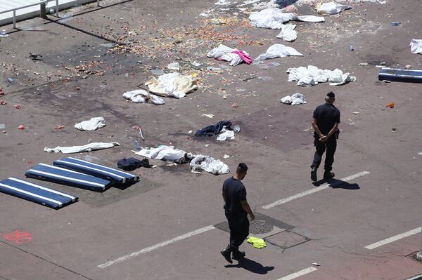 French gendarmes walk past clothes and mattresses at the site of the deadly attack on the Promenade des Anglais seafront in the French Riviera city of Nice on July 15, 2016, after a gunman smashed a truck through a crowd celebrating Bastille Day, killing at least 84 and injuring dozens - Sputnik International