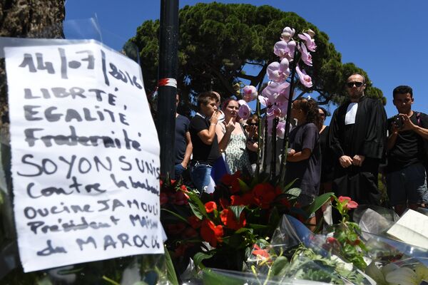 A sign reading Liberty, equality, fraternity, let us unite against barbarism is placed on July 15, 2016 at a makeshift memorial near the site in Nice where a gunman smashed a truck into a crowd of revellers celebrating Bastille Day, killing at least 84 people. A sign reading Liberty, equality, fraternity, let us unite against barbarism is placed on July 15, 2016 at a makeshift memorial near the site in Nice where a gunman smashed a truck into a crowd of revellers celebrating Bastille Day, killing at least 84 people. - Sputnik International