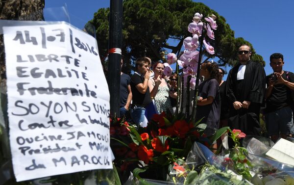 A sign reading Liberty, equality, fraternity, let us unite against barbarism is placed on July 15, 2016 at a makeshift memorial near the site in Nice where a gunman smashed a truck into a crowd of revellers celebrating Bastille Day, killing at least 84 people. - Sputnik International