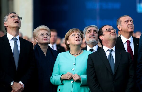 From left, NATO Secretary General, Lithuanian President Dalia Grybauskaite, German Chancellor Angela Merkel, French President Francois Hollande and Turkey’s President Recep Tayyip Erdogan watch a fly-past by NATO air forces planes during the NATO summit in Warsaw, Poland, Friday, July 8, 2016. - Sputnik International