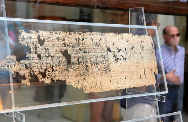 A tourist looks at Papyrus of King Khufu at the opening exhibition of 'The Papyri of Khufu from Wadi al-Jarf' for the first time at the Egyptian Museum in Cairo, Egypt, July 14, 2016. A tourist looks at Papyrus of King Khufu at the opening exhibition of 'The Papyri of Khufu from Wadi al-Jarf' for the first time at the Egyptian Museum in Cairo, Egypt, July 14, 2016. - Sputnik International