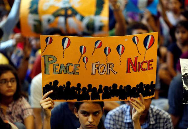 A girl holds up a placard during a prayer meet to show solidarity with the victims of the Bastille Day truck attack in Nice, at a school in Ahmedabad, India, July 15, 2016. A girl holds up a placard during a prayer meet to show solidarity with the victims of the Bastille Day truck attack in Nice, at a school in Ahmedabad, India, July 15, 2016. - Sputnik International