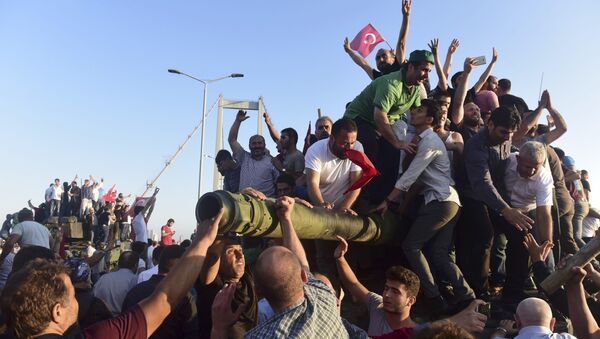 Supporters of Tukish President Tayyip Erdogan celebrate after soldiers involved in the coup surrendered on the Bosphorus Bridge in Istanbul, Turkey July 16, 2016 - Sputnik International