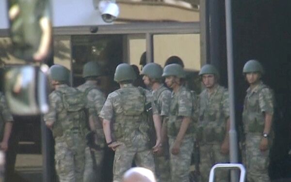 still image from video shows armed soldiers waiting at the entrance of TRT state television as they prepare to surrender to the police after a failed coup attempt, in Istanbul, Turkey July 16, 2016 - Sputnik International