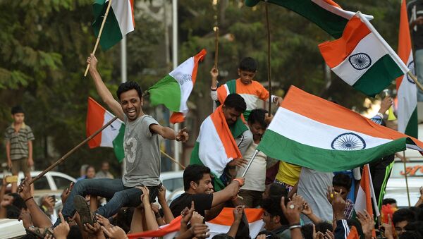 Indian fans wave national flags as they celebrate after India won the 2015 Cricket World Cup's cricket match against Pakistan, on the streets of Mumbai - Sputnik International