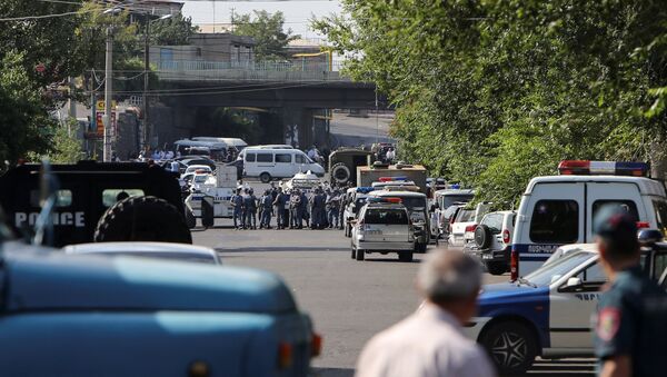 Policemen block a street after group of armed men seized a police station along with an unknown number of hostages, according the country's security service, in Yerevan, Armenia, July 17, 2016. - Sputnik International