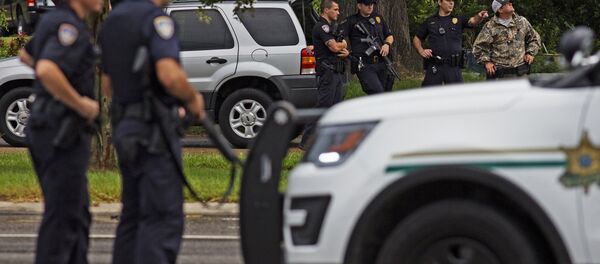 Law enforcement officers man a road block on Airline Highway and Goodwood Blvd. after police were shot earlier in the day in Baton Rouge. Law enforcement officers man a road block on Airline Highway and Goodwood Blvd. after police were shot earlier in the day in Baton Rouge. - Sputnik International