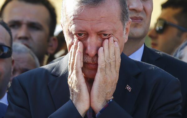 Turkish President Recep Tayyip Erdogan right, wipes his tears during the funeral of Mustafa Cambaz, Erol and Abdullah Olcak, killed Friday while protesting the attempted coup against Turkey's government, in Istanbul, Sunday, July 17, 2016. - Sputnik International