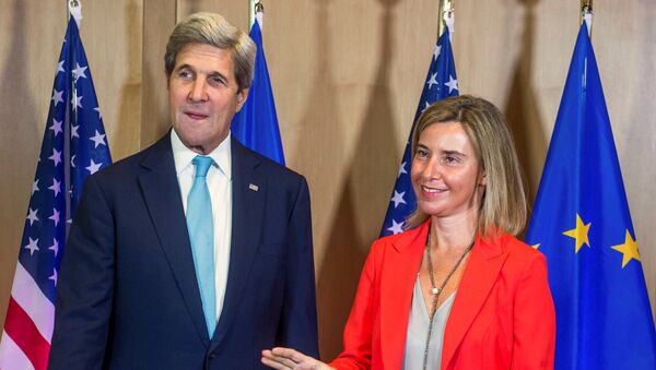 U.S. Secretary of State John Kerry poses with EU foreign policy chief Federica Mogherini (R) during an European Union foreign ministers meeting in Brussels, Belgium, July 18, 2016. - Sputnik International