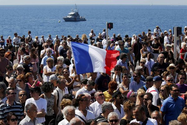 A French flag flies among the crowd as people gather in front of the Monument du Centenaire during a minute of silence on the third day of national mourning to pay tribute to victims of the truck attack along the Promenade des Anglais on Bastille Day that killed scores and injured as many in Nice, France, July 18, 2016. A French flag flies among the crowd as people gather in front of the Monument du Centenaire during a minute of silence on the third day of national mourning to pay tribute to victims of the truck attack along the Promenade des Anglais on Bastille Day that killed scores and injured as many in Nice, France, July 18, 2016. - Sputnik International
