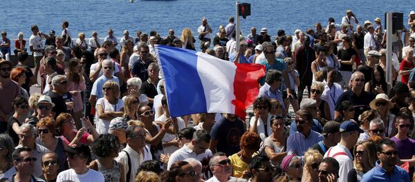 A French flag flies among the crowd as people gather in front of the Monument du Centenaire during a minute of silence on the third day of national mourning to pay tribute to victims of the truck attack along the Promenade des Anglais on Bastille Day that killed scores and injured as many in Nice, France, July 18, 2016. A French flag flies among the crowd as people gather in front of the Monument du Centenaire during a minute of silence on the third day of national mourning to pay tribute to victims of the truck attack along the Promenade des Anglais on Bastille Day that killed scores and injured as many in Nice, France, July 18, 2016. - Sputnik International