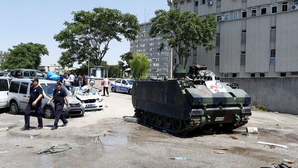 Damaged cars are seen next to an armored military vehicle in front of the police headquarters in Ankara, Turkey, July 18, 2016. - Sputnik International