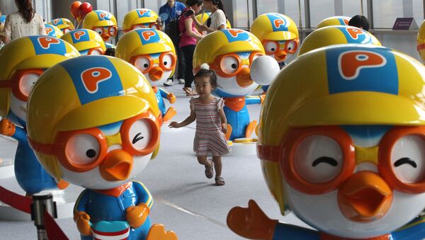 A girl passes by dolls featuring South Korean animation character Pororo displayed at a character licensing show in Seoul, South Korea, Friday, July 19, 2013 - Sputnik International