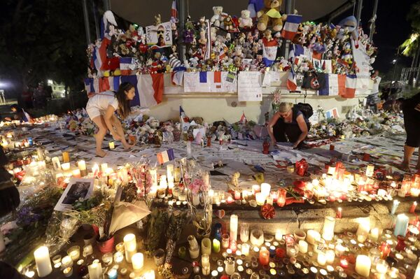 Volunteers install items at a new memorial in a gazebo in a seaside park on the famed Promenade des Anglais in Nice, southern France, Monday, July 18, 2016. Volunteers install items at a new memorial in a gazebo in a seaside park on the famed Promenade des Anglais in Nice, southern France, Monday, July 18, 2016. - Sputnik International