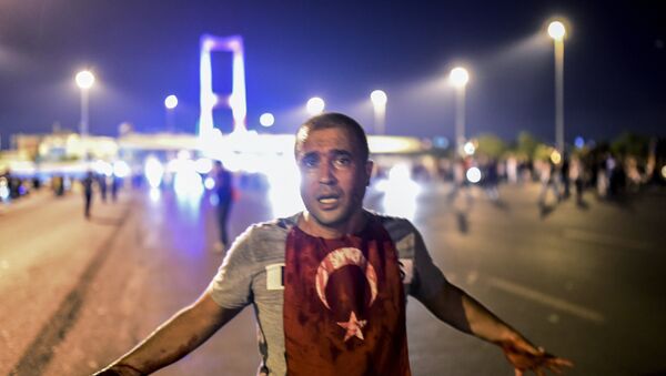 A man covered with blood stands near the Bosphorus bridge as Turkish military clash with people at the entrance to the bridge in Istanbul on July 16, 2016 - Sputnik International