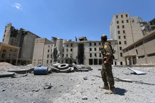 A Syria Democratic Forces (SDF) fighter walks in the silos and mills of Manbij after the SDF took control of it, in Aleppo Governorate, Syria, July 1, 2016 A Syria Democratic Forces (SDF) fighter walks in the silos and mills of Manbij after the SDF took control of it, in Aleppo Governorate, Syria, July 1, 2016 - Sputnik International