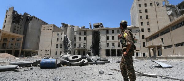 A Syria Democratic Forces (SDF) fighter walks in the silos and mills of Manbij after the SDF took control of it, in Aleppo Governorate, Syria, July 1, 2016 A Syria Democratic Forces (SDF) fighter walks in the silos and mills of Manbij after the SDF took control of it, in Aleppo Governorate, Syria, July 1, 2016 - Sputnik International