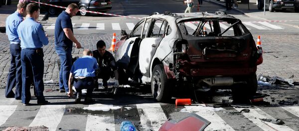 Investigators inspect a damaged car at the site where journalist Pavel Sheremet was killed by a car bomb in central Kiev, Ukraine, July 20, 2016 Investigators inspect a damaged car at the site where journalist Pavel Sheremet was killed by a car bomb in central Kiev, Ukraine, July 20, 2016 - Sputnik International