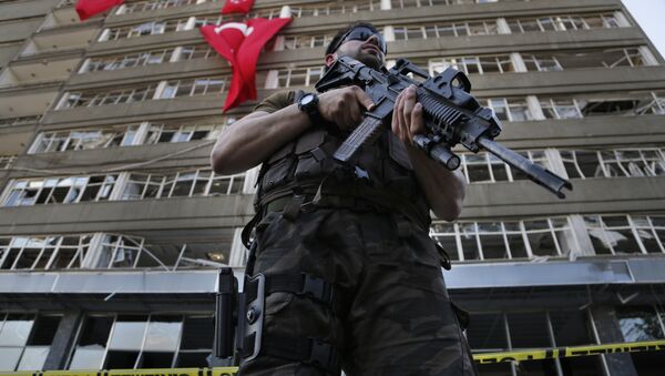 A Turkish special forces policeman stands guard in front the damaged building of the police headquarters which was attacked by the Turkish warplanes during the failed military coup, in Ankara, Turkey, Tuesday, July 19, 2016 - Sputnik International