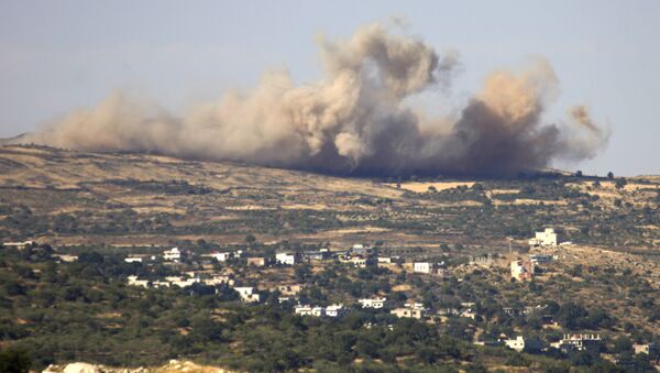 FILE PHOTO A picture taken from the Israeli-annexed Golan Heights shows smoke rising from the Syrian Druze village of Hader, on June 16, 2015 - Sputnik International