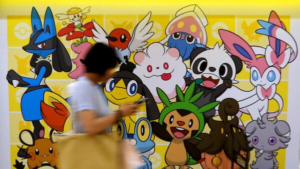 A woman using a mobile phone walks past a shop selling Pokemon goods in Tokyo, Japan July 20, 2016. - Sputnik International
