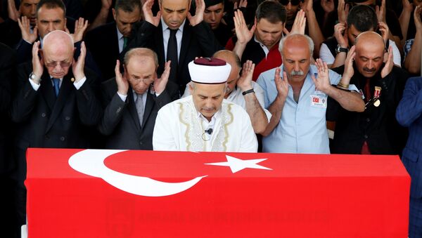 People pray during a funeral ceremony for two Turkish police officers who were killed in the thwarted coup in Ankara, Turkey, July 20, 2016 - Sputnik International