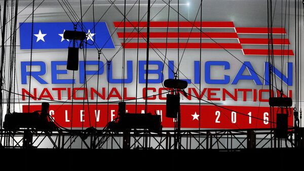 A Republican National Convention logo is seen though silhouetted production equipment on a huge video screen at Quicken Loans Arena for the Republican National Convention. - Sputnik International