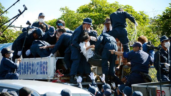 People protesting against restarting the construction of helipads for US forces clash with riot police in Higashi-son, Okinawa prefecture on July 22, 2016 - Sputnik International