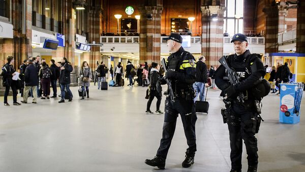 Dutch officers carry out extra patrols at the Central Station in Amsterdam, The Netherlands, 22 March 2016 - Sputnik International