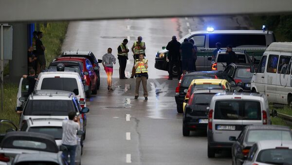 Police halt traffic on a road near to the scene of a shooting rampage at the Olympia shopping mall in Munich, Germany July 22, 2016 - Sputnik International