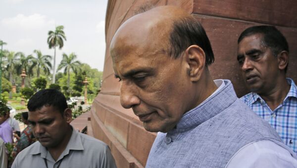 Indian Home Minister Rajnath Singh, centre, comes out from parliament house. - Sputnik International