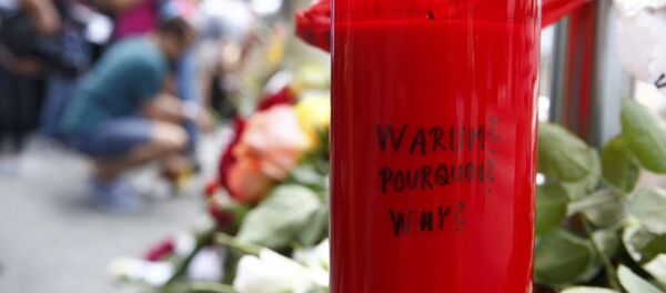 A candle with the words 'Why?' written upon it is placed next to flowers near the Olympia shopping mall, where yesterday's shooting rampage started, in Munich, Germany July 23, 2016. A candle with the words 'Why?' written upon it is placed next to flowers near the Olympia shopping mall, where yesterday's shooting rampage started, in Munich, Germany July 23, 2016. - Sputnik International