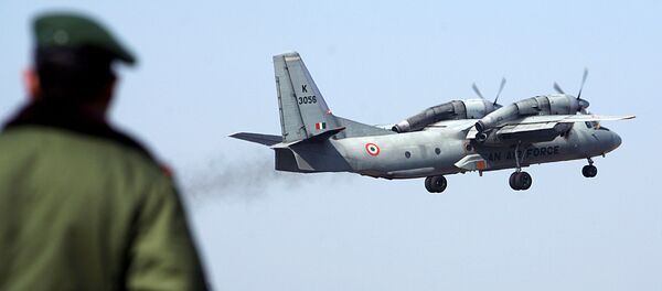 A soldier stands guard as an Indian Air Force AN-32 transport aircraft. A soldier stands guard as an Indian Air Force AN-32 transport aircraft. - Sputnik International