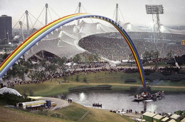 A rainbow in the five Olympic colors is displayed during the closing ceremony of the Summer Olympic Games on September 11, 1972 at the Olympic Stadium in Munich, Germany. (File) - Sputnik International