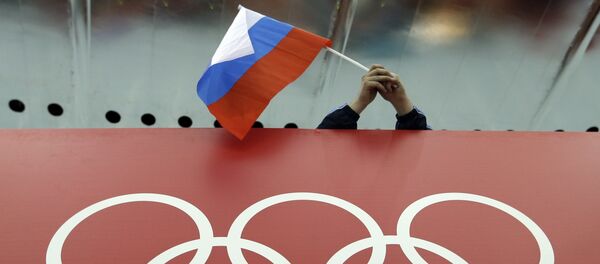 Russian skating fan holds the country's national flag over the Olympic rings before the start of the men's 10,000-meter speedskating race at Adler Arena Skating Center during the 2014 Winter Olympics in Sochi, Russia. (File) Russian skating fan holds the country's national flag over the Olympic rings before the start of the men's 10,000-meter speedskating race at Adler Arena Skating Center during the 2014 Winter Olympics in Sochi, Russia. (File) - Sputnik International