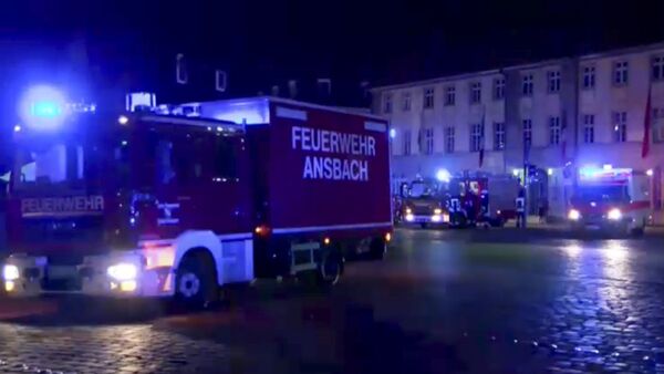 In this image taken from video fire trucks and ambulances stand in the city center of Ansbach near Nuremberg, southern Germany, Monday morning, July 25, 2016, after a man was killed when an explosive device he was believed to be carrying went off near an open-air music festival, injuring 12 others. - Sputnik International