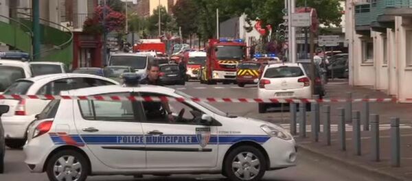 In this grab made from video, police officers close off a road during a hostage situation in Normandy, France, Tuesday, July 26, 2016. - Sputnik International