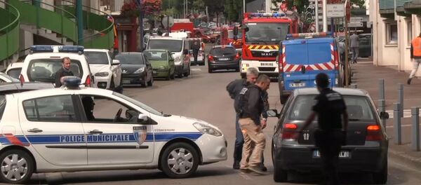 In this grab made from video, police officers speak to a driver as they close off a road during a hostage situation in Normandy, France, Tuesday, July 26, 2016. - Sputnik International