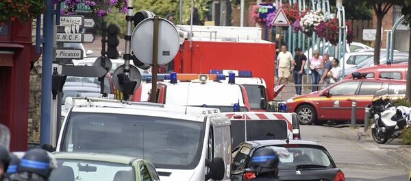 Police and rescue workers stand at the scene after two assailants had taken five people hostage in the church at Saint-Etienne-du -Rouvray near Rouen in Normandy, France Police and rescue workers stand at the scene after two assailants had taken five people hostage in the church at Saint-Etienne-du -Rouvray near Rouen in Normandy, France - Sputnik International