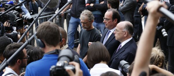 French President Francois Hollande (C) flanked by Hubert Wulfranc mayor of Saint-Etienne-du-Rouvray (L) and French Interior Minister Bernard Cazeneuve (R), speaks to the press as he leaves the Saint-Etienne-du-Rouvray's city hall following a hostage-taking at a church of the town on July 26, 2016 that left the priest dead. French President Francois Hollande (C) flanked by Hubert Wulfranc mayor of Saint-Etienne-du-Rouvray (L) and French Interior Minister Bernard Cazeneuve (R), speaks to the press as he leaves the Saint-Etienne-du-Rouvray's city hall following a hostage-taking at a church of the town on July 26, 2016 that left the priest dead. - Sputnik International