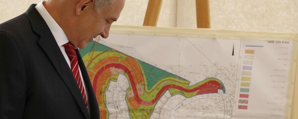 Israeli Prime Minister Benjamin Netanyahu looks at a map of the area where Israel plans to build some 800 new housing units during his visit to the east Jerusalem Jewish neighborhood of Gilo. Israeli Prime Minister Benjamin Netanyahu looks at a map of the area where Israel plans to build some 800 new housing units during his visit to the east Jerusalem Jewish neighborhood of Gilo. - Sputnik International