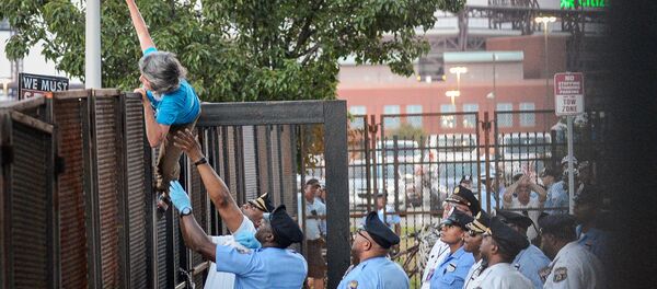 A protester is detained by police after climbing over a barrier near the site of the Democratic National Convention in Philadelphia, Pennsylvania, U.S., July 26, 2016 A protester is detained by police after climbing over a barrier near the site of the Democratic National Convention in Philadelphia, Pennsylvania, U.S., July 26, 2016 - Sputnik International