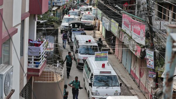 Ambulances carrying bodies of killed suspected Islamic militants leave the premises of a five-story building that was raided by police in Dhaka, Bangladesh, Tuesday, July 26, 2016 - Sputnik International