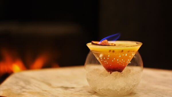 Red/Charmander: 25ml Belvedere Vodka, 45ml Passion Fruit Puree, 5ml Gomme Syrup, 10ml Grenadine. Topped with a flaming Passion Fruit. - Sputnik International