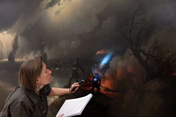 Fine art restorer at the State Tretyakov Gallery Alexandra Orlovskaya near the painting Peter the Great Lights a Fire at Krasnoy Gorka as a Signal for His Fleet in Distress during the installation of exhibits ahead of the exhibition Ivan Aivazovsky. For the 200th anniversary. Moscow's State Tretyakov Gallery - Sputnik International