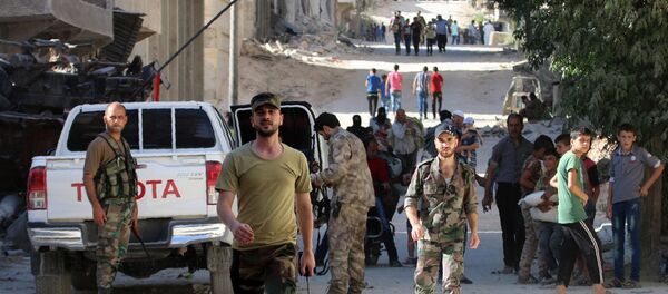 Syrian government forces secure a street as civilians walk on a street in the neighbourhood of Bani Zeid, on Aleppo's northern outskirts on July 29, 2016 Syrian government forces secure a street as civilians walk on a street in the neighbourhood of Bani Zeid, on Aleppo's northern outskirts on July 29, 2016 - Sputnik International