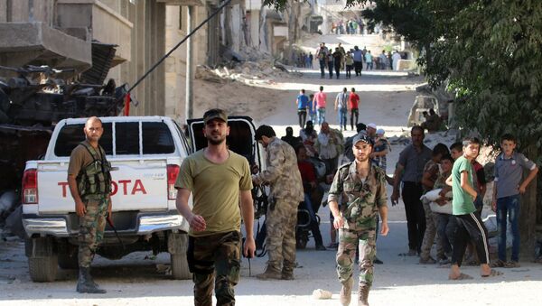 Syrian government forces secure a street as civilians walk on a street in the neighbourhood of Bani Zeid, on Aleppo's northern outskirts on July 29, 2016 - Sputnik International