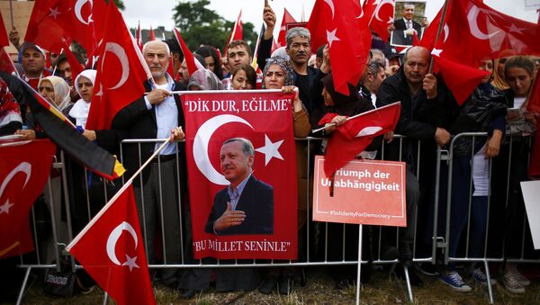 Supporters of Turkish President Tayyip Erdogan hold Turkish flags during a pro-government protest in Cologne, Germany - Sputnik International