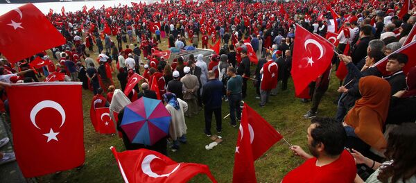 Supporters of Turkish President Tayyip Erdogan wave Turkish flags during a pro-government protest in Cologne, Germany July 31, 2016. Supporters of Turkish President Tayyip Erdogan wave Turkish flags during a pro-government protest in Cologne, Germany July 31, 2016. - Sputnik International