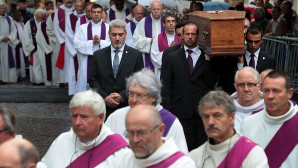 Pallbearers carry the coffin of the priest Jacques Hamel as they enter in Rouen's cathedral during the funeral of the priest who was killed in a church in Saint-Etienne-du-Rouvray on July 26 during a hostage-taking claimed by Islamic State group - Sputnik International